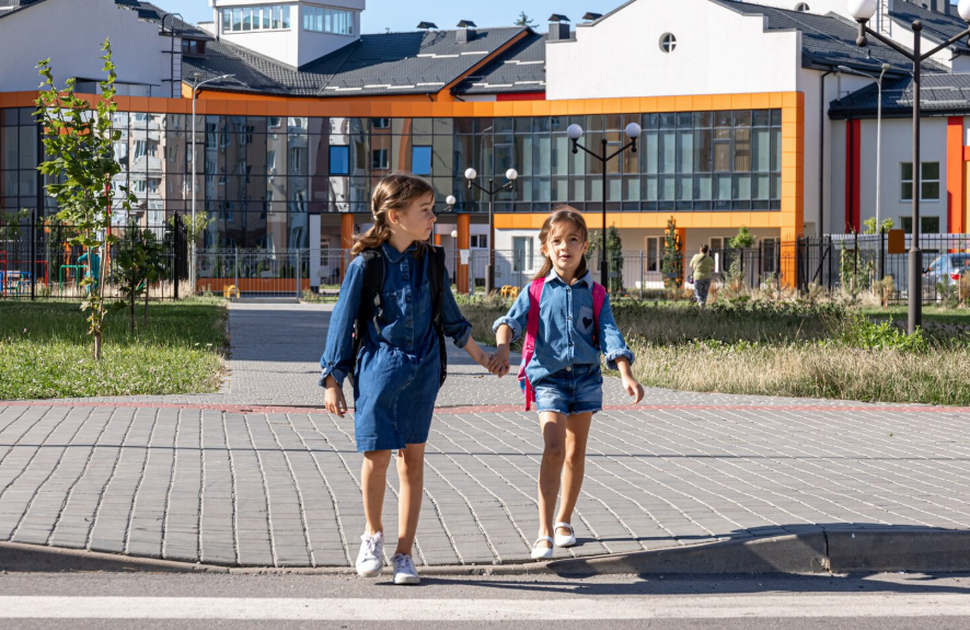 children walking near school showing how school districts affect home value and demand