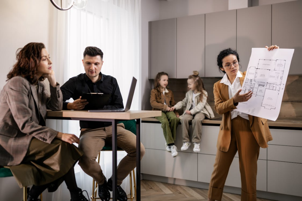 overvalued vs undervalued property discussion with buyers reviewing home layout and pricing factors